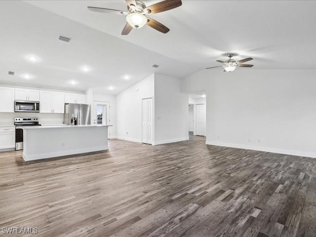 unfurnished living room featuring ceiling fan, wood-type flooring, and lofted ceiling