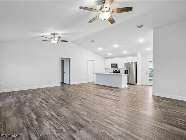 unfurnished living room featuring hardwood / wood-style flooring, ceiling fan, and vaulted ceiling