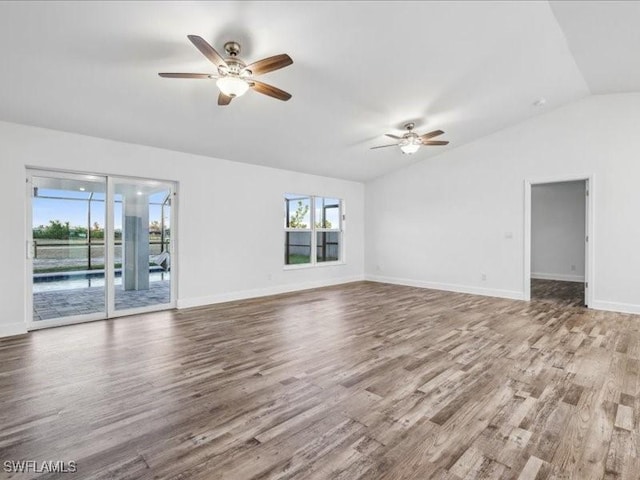 unfurnished living room featuring ceiling fan, hardwood / wood-style floors, and lofted ceiling