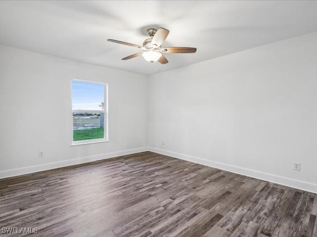 spare room featuring ceiling fan and dark hardwood / wood-style flooring