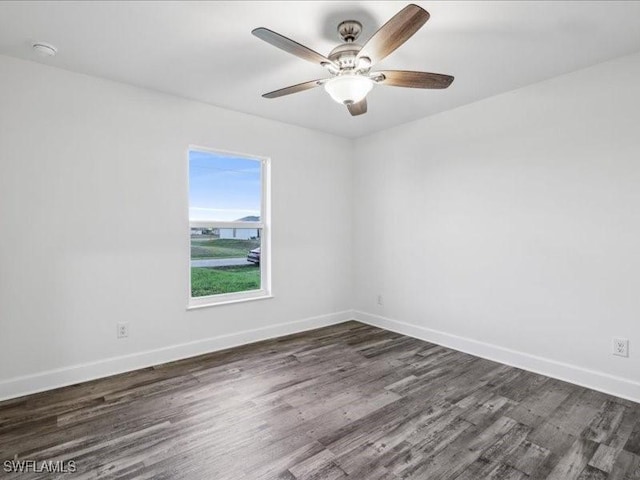 unfurnished room with ceiling fan and dark wood-type flooring