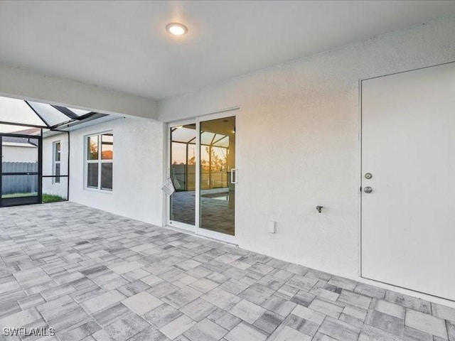 view of patio / terrace featuring glass enclosure