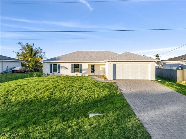 ranch-style house featuring a garage and a front lawn