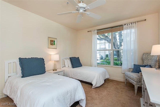 bedroom featuring ceiling fan, carpet flooring, and baseboards