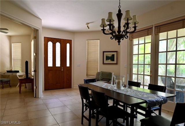 dining space with light tile patterned floors and a chandelier