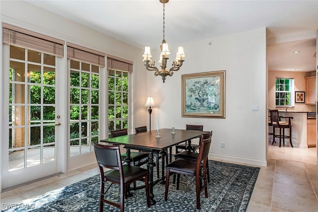 dining room featuring an inviting chandelier, baseboards, a wealth of natural light, and recessed lighting