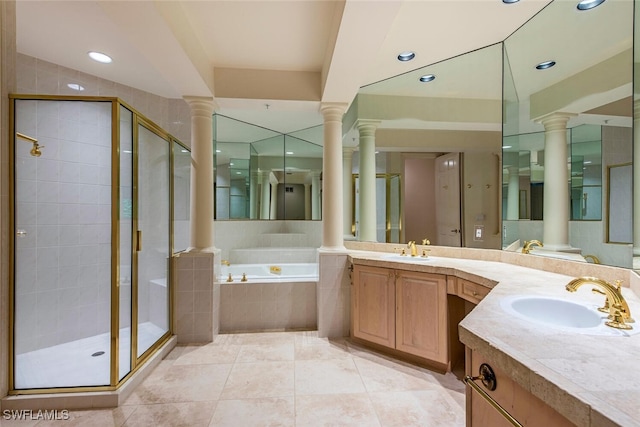 full bath with a sink, decorative columns, and a shower stall