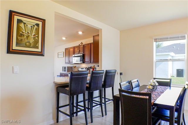 dining area featuring light tile patterned floors