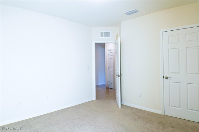 unfurnished bedroom with light colored carpet