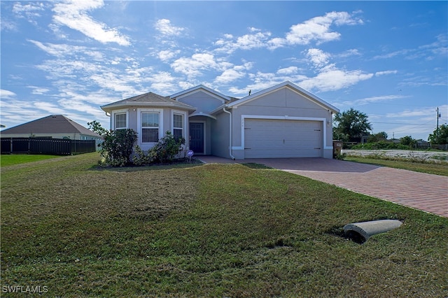 ranch-style home with a garage and a front lawn