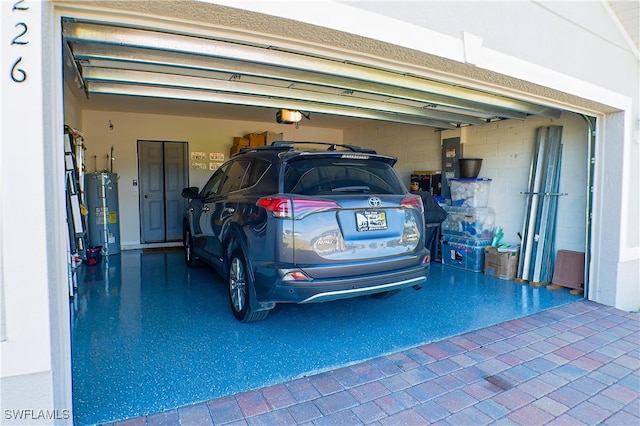 garage featuring a garage door opener and water heater