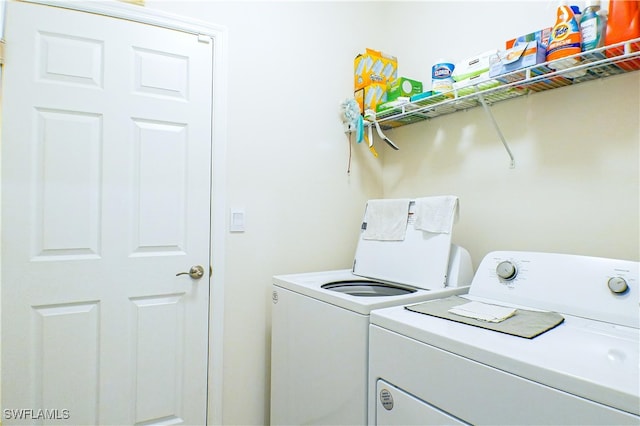 clothes washing area featuring separate washer and dryer