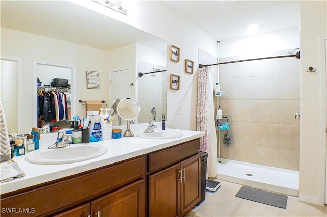 bathroom with tile patterned floors, vanity, and walk in shower