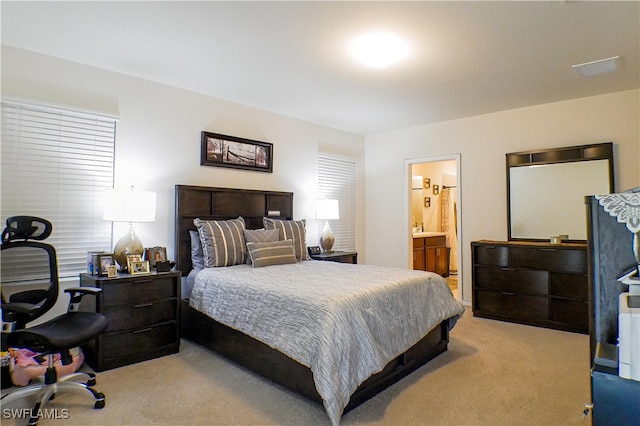 carpeted bedroom with ensuite bath