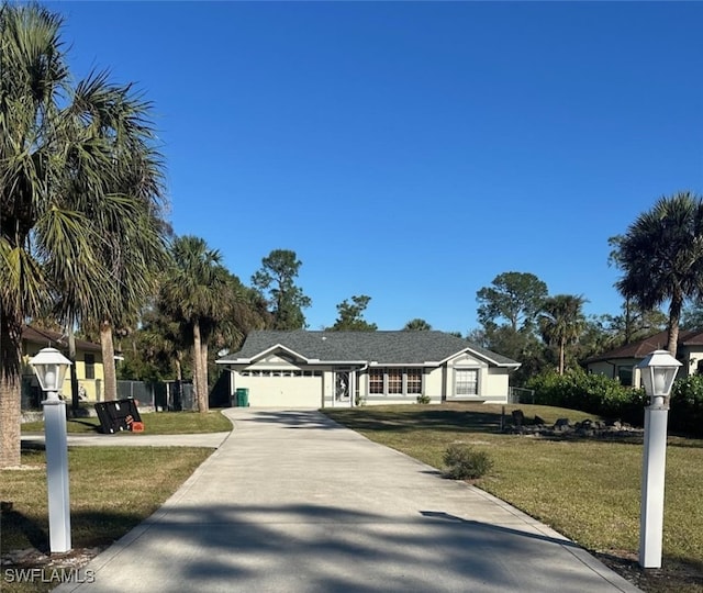 single story home featuring a garage and a front lawn