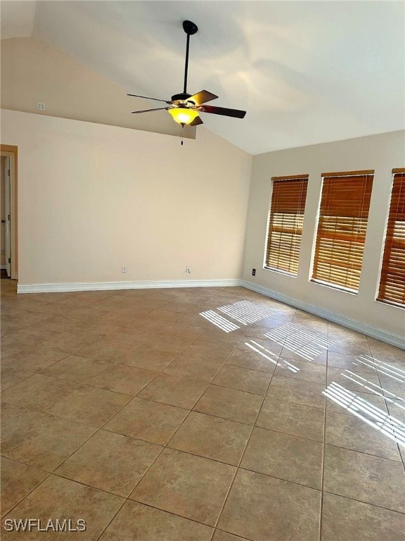 tiled empty room with ceiling fan and lofted ceiling