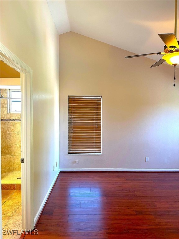 unfurnished room with wood-type flooring, vaulted ceiling, and ceiling fan