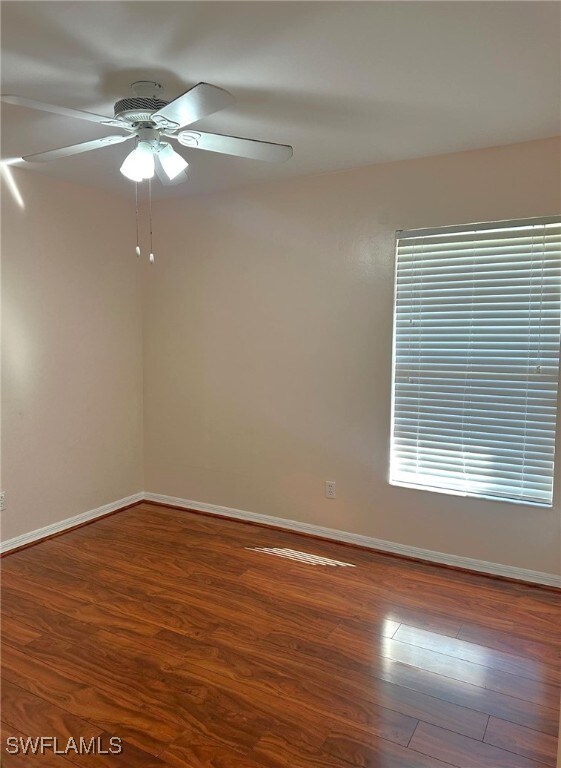 unfurnished room with hardwood / wood-style floors and ceiling fan