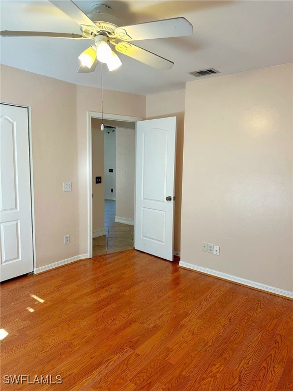 unfurnished bedroom with hardwood / wood-style flooring and ceiling fan