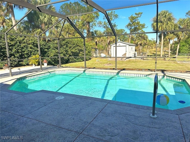 view of swimming pool featuring a storage shed, a lanai, a yard, and a patio