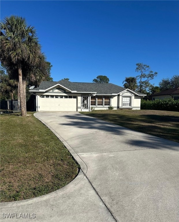 ranch-style house with a garage and a front lawn