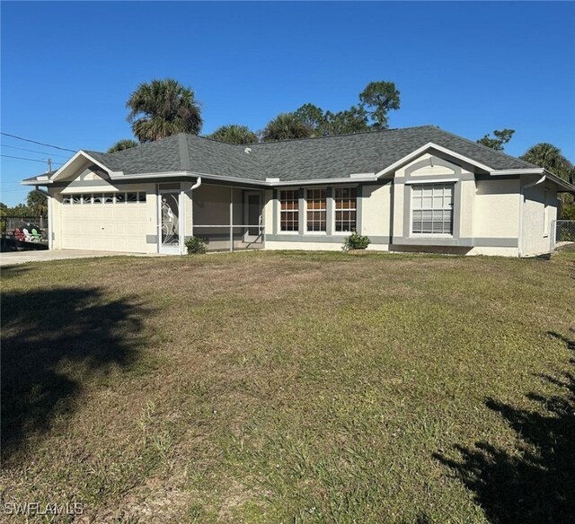 single story home with a garage and a front yard