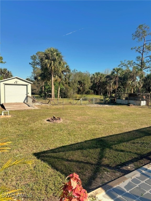 view of yard with a garage and an outdoor structure