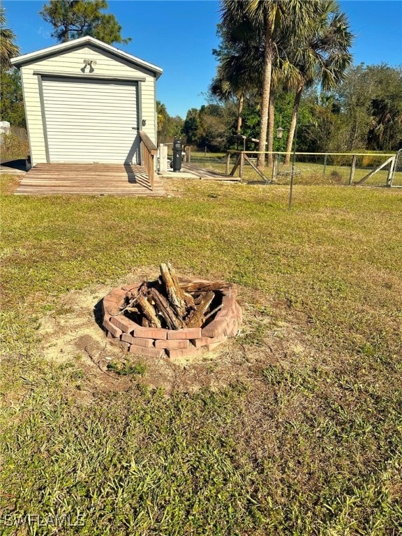 view of yard featuring a storage shed and an outdoor fire pit