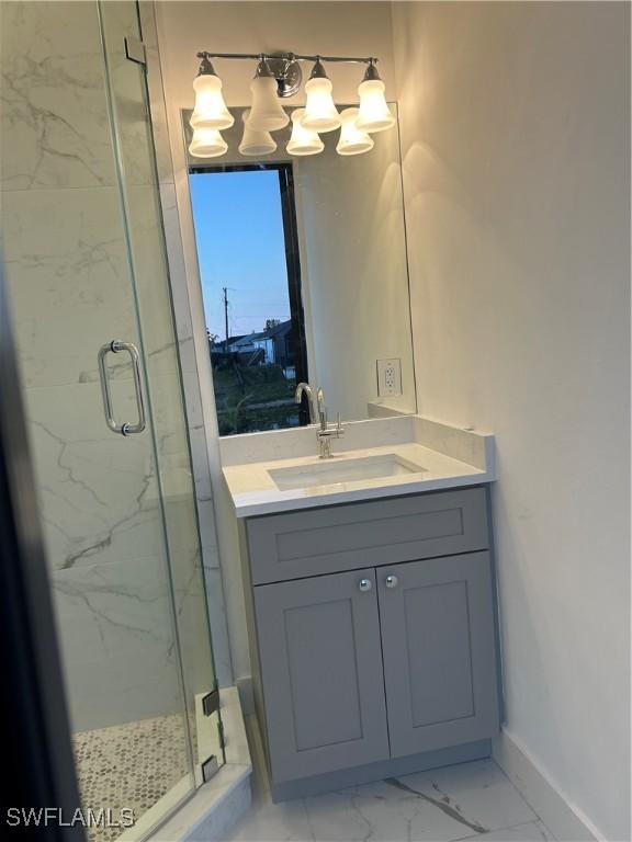 bathroom with vanity and a shower with shower door