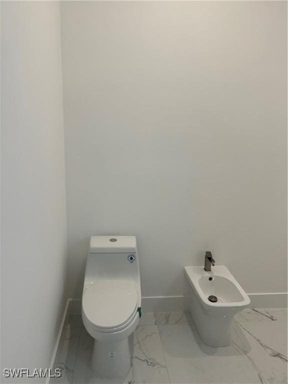 bathroom featuring a bidet and toilet