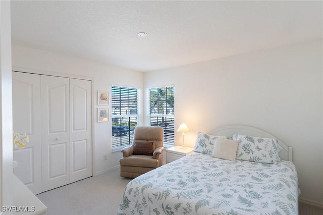 carpeted bedroom featuring a closet