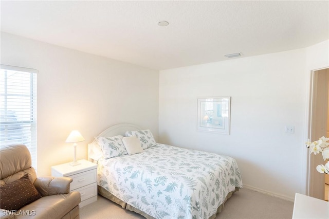 bedroom with light colored carpet