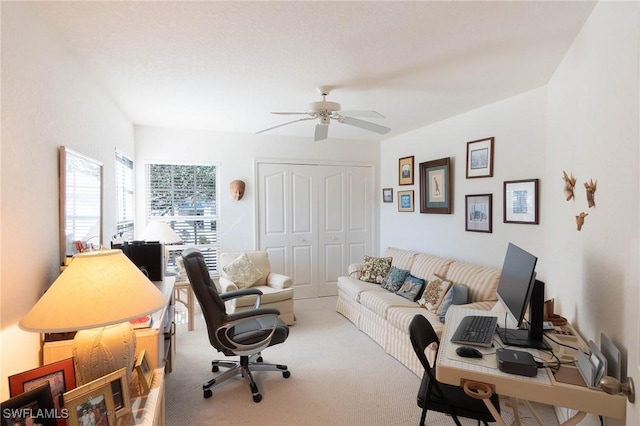 carpeted living room featuring ceiling fan