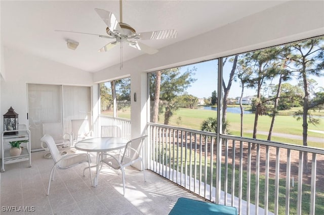 sunroom featuring vaulted ceiling, a water view, and ceiling fan