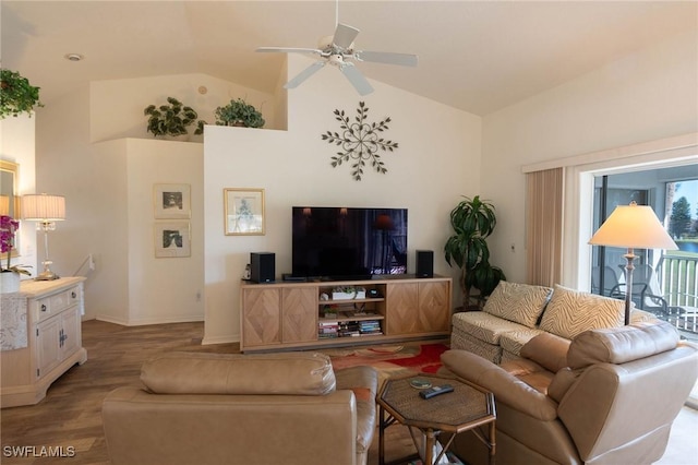 living room with ceiling fan, light hardwood / wood-style floors, and vaulted ceiling