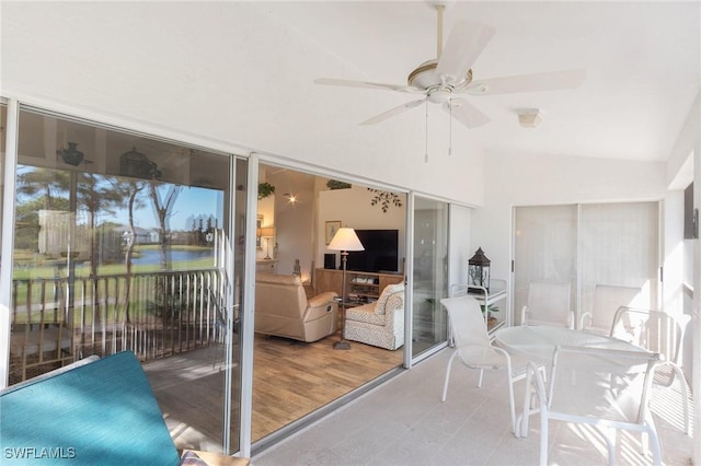 sunroom / solarium with ceiling fan and lofted ceiling