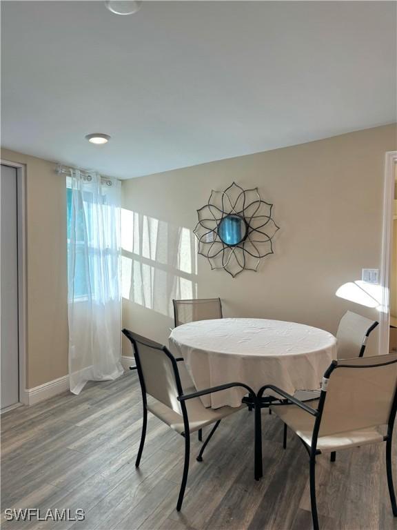 dining area with wood-type flooring