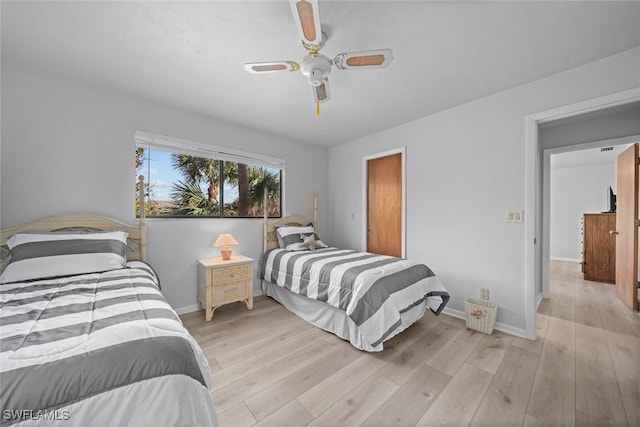 bedroom with ceiling fan and light hardwood / wood-style floors