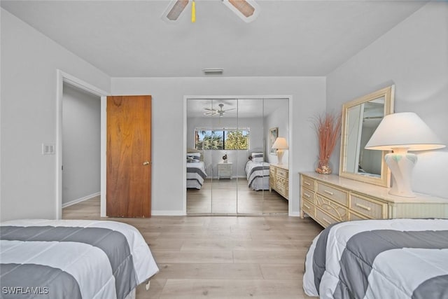 bedroom with light wood-type flooring, a closet, and ceiling fan