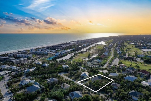 aerial view at dusk with a water view