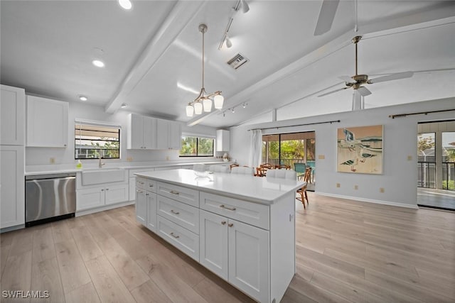 kitchen featuring white cabinetry, dishwasher, lofted ceiling with beams, and sink