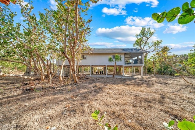 view of front of house featuring a sunroom and a carport