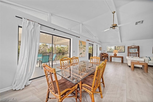 dining space with lofted ceiling with beams, light hardwood / wood-style floors, and ceiling fan