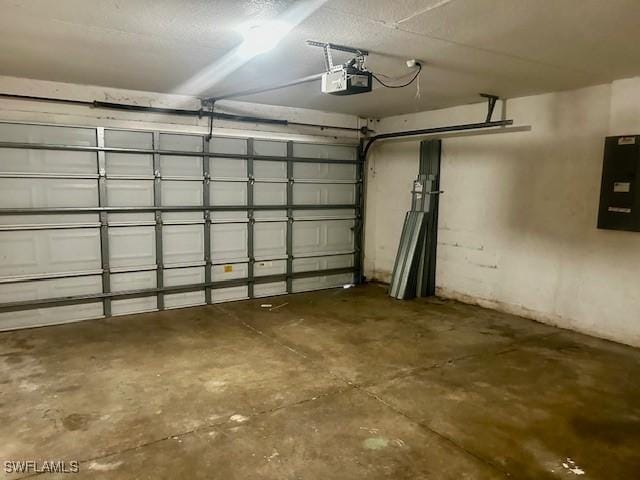 garage with a garage door opener and electric panel