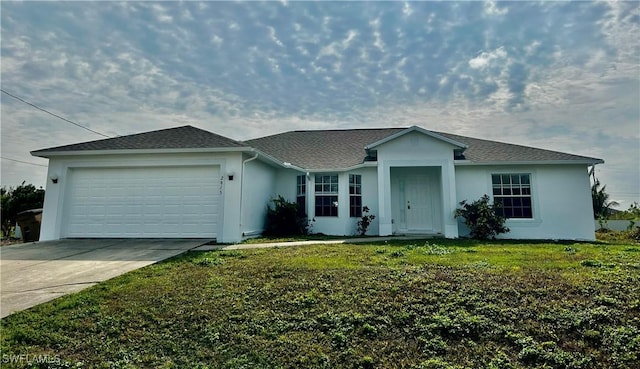 ranch-style house featuring a garage and a front lawn