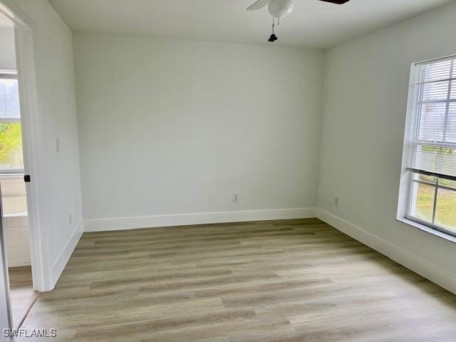 empty room with light wood-type flooring and ceiling fan