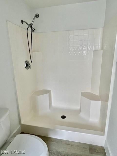 bathroom featuring toilet and a shower