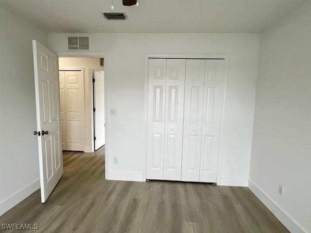 unfurnished bedroom featuring a closet, ceiling fan, and hardwood / wood-style flooring