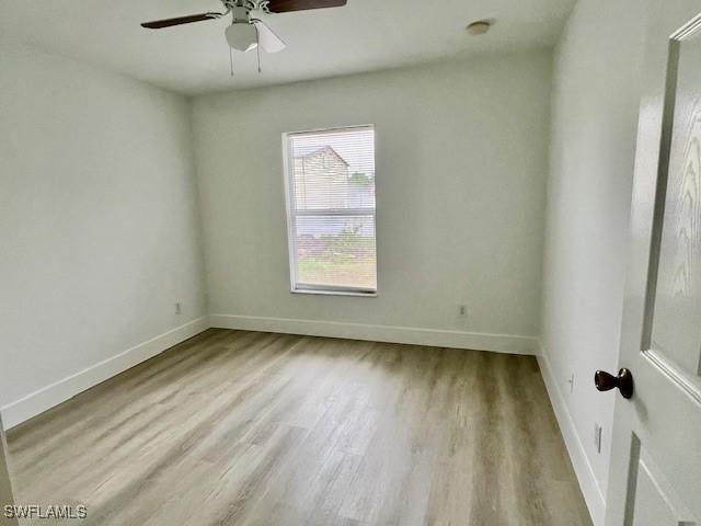 unfurnished room with light wood-type flooring and ceiling fan