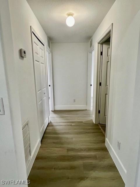 hallway with dark hardwood / wood-style floors